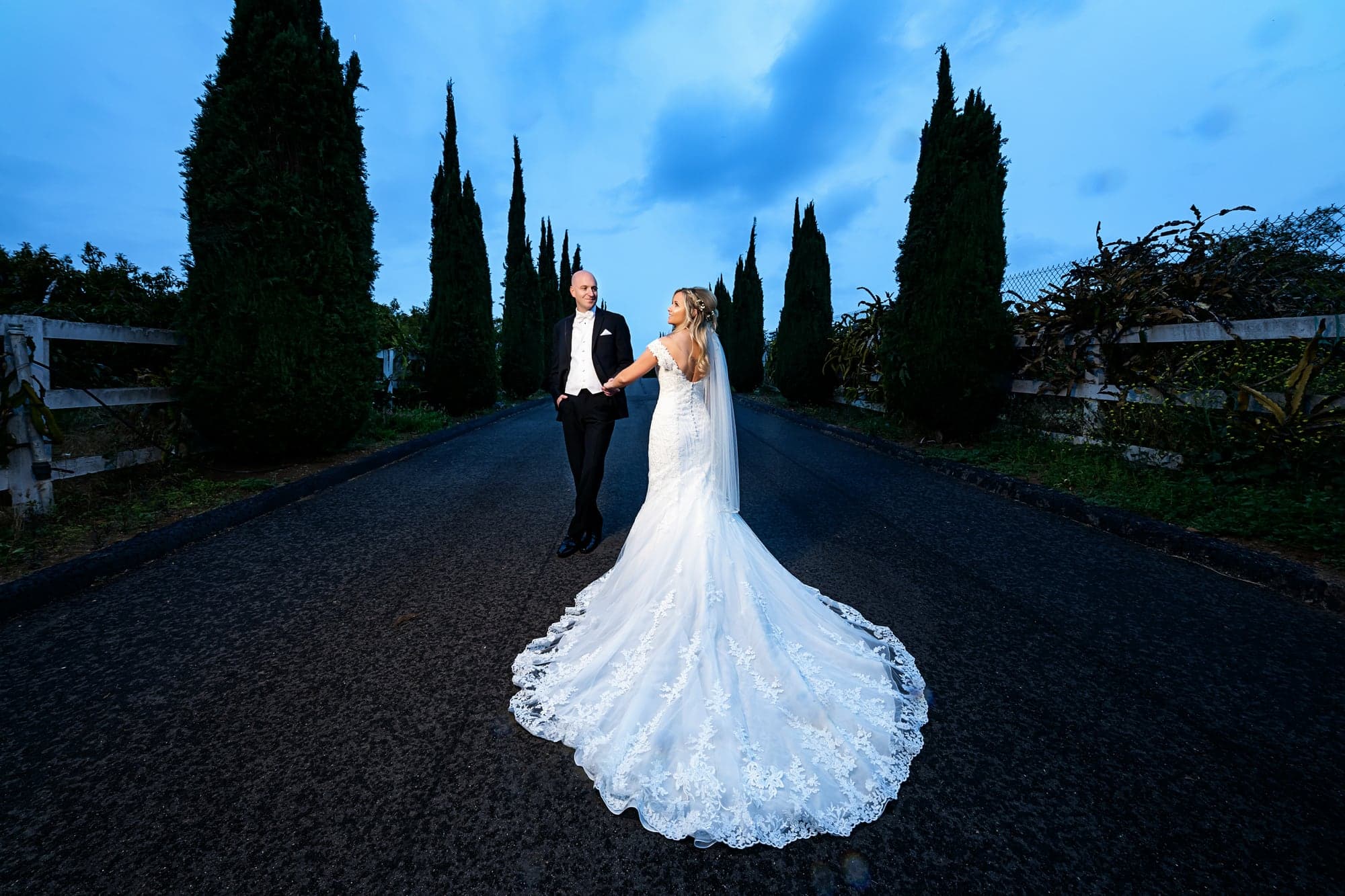 Stephanie and Tim posing beneath the evening sky at Bella Vista Groves