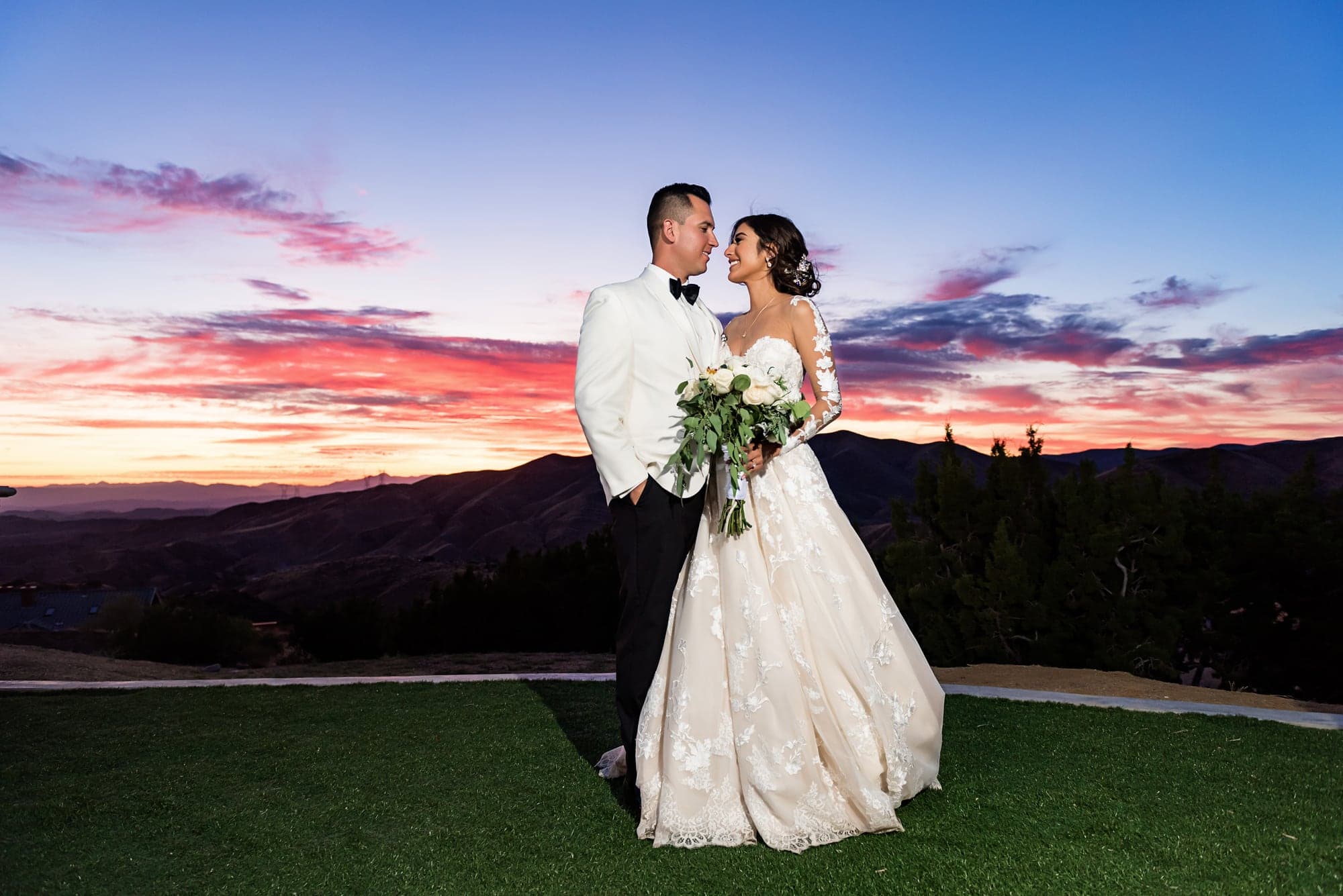 Liz and Ozzy beneath the colorful sunset at Diamond View Summit