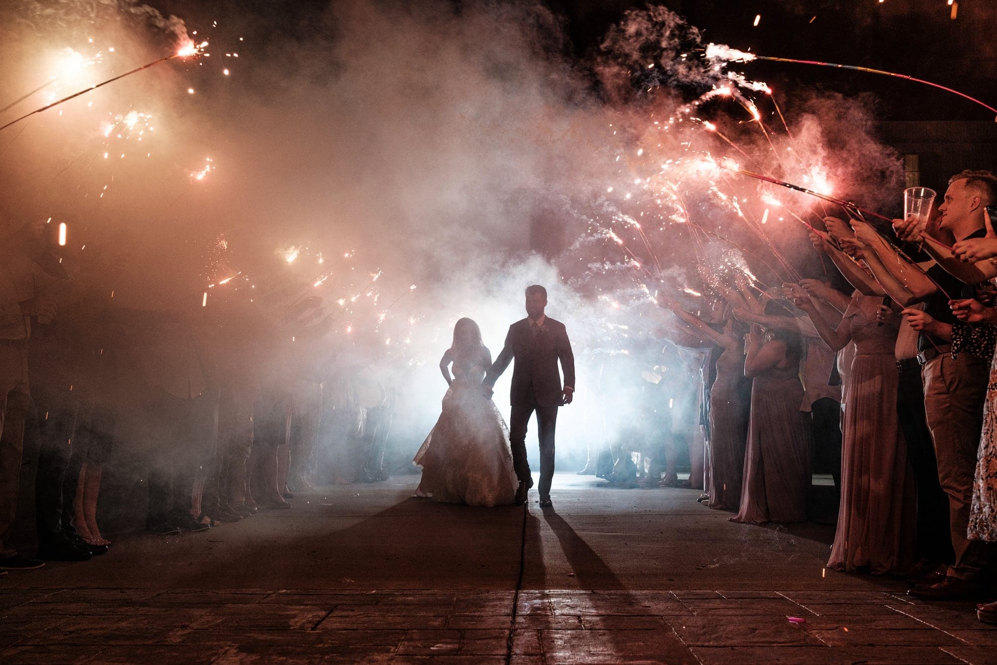 Amber and Joshua standing together beneath cold sparks at The Barn at Fiddle Dee Farms near Nashville, photographed by Michael Anthony Photography