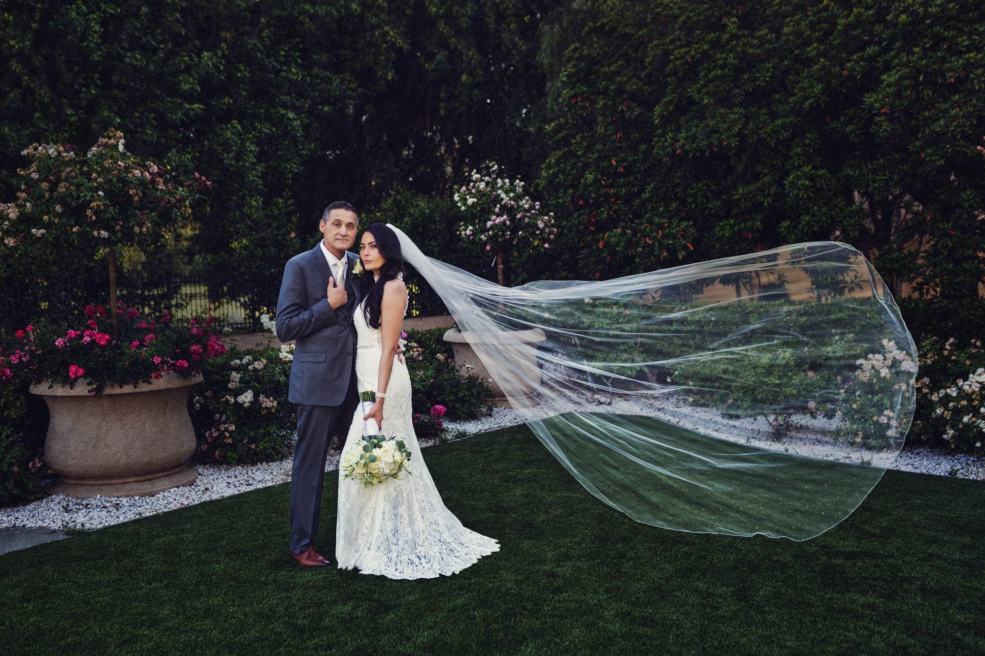 Maritza and Ignacio embracing in the garden at Hyatt Regency Valencia