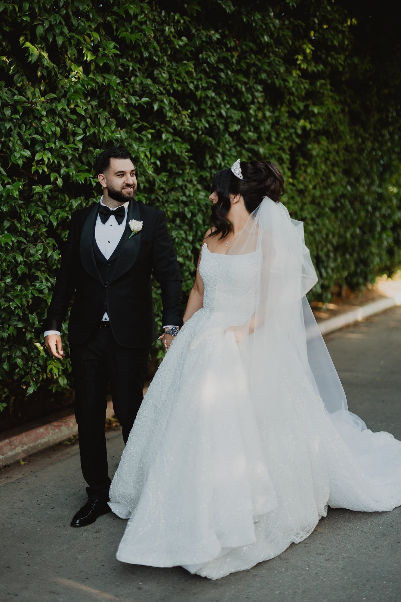 Amanda and Anthony walking together after their cathedral wedding ceremony