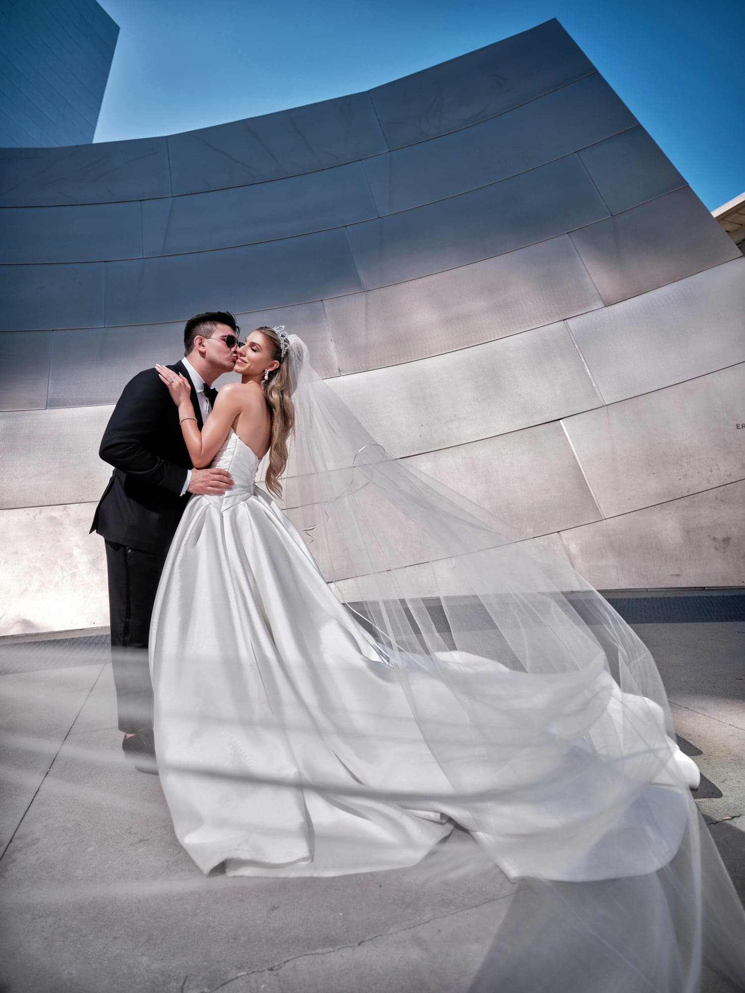 Angelina and Gevork kissing beside the metallic curves of Walt Disney Concert Hall