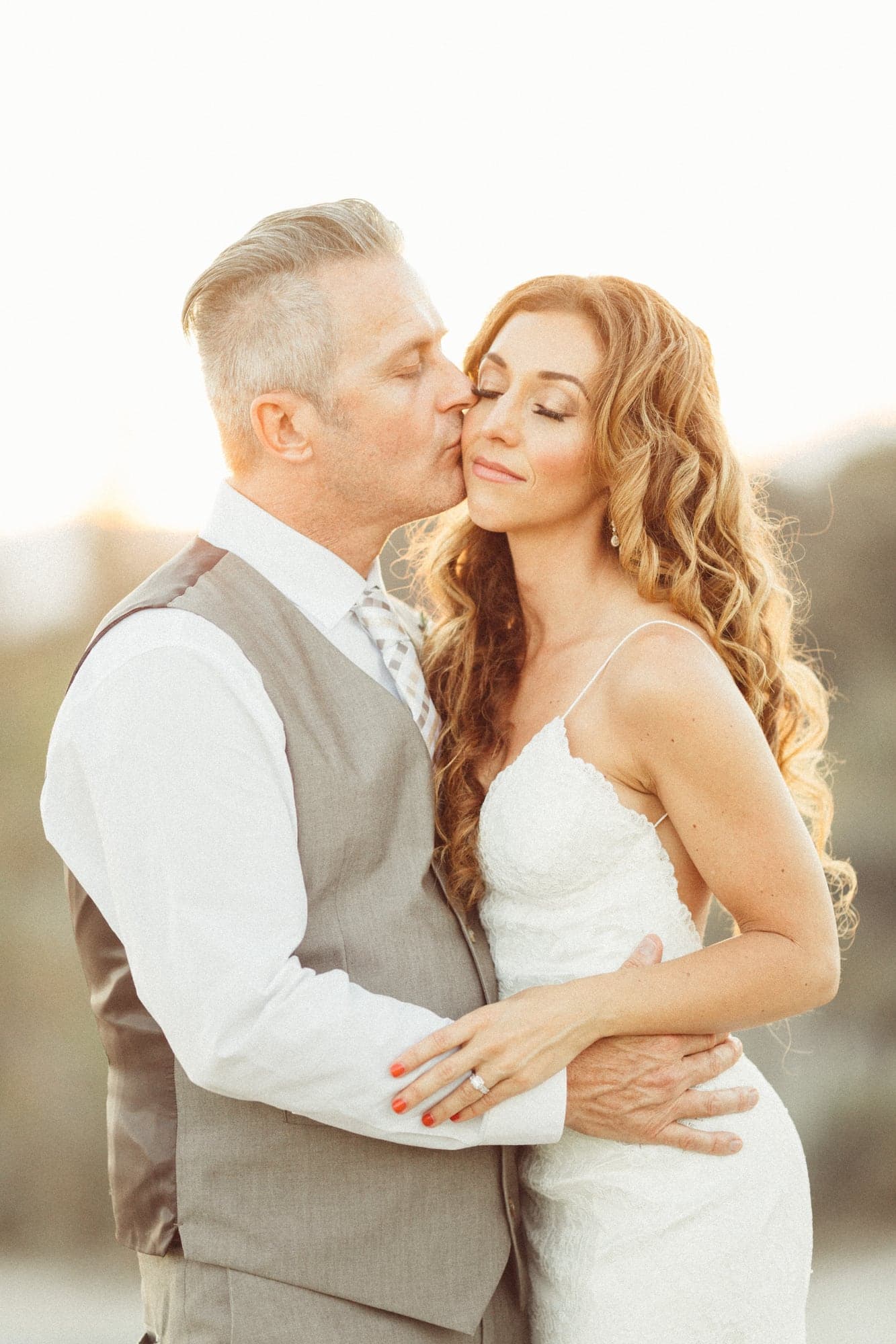 The Heidt couple sharing a warm sunset portrait at Sand Canyon Ranch