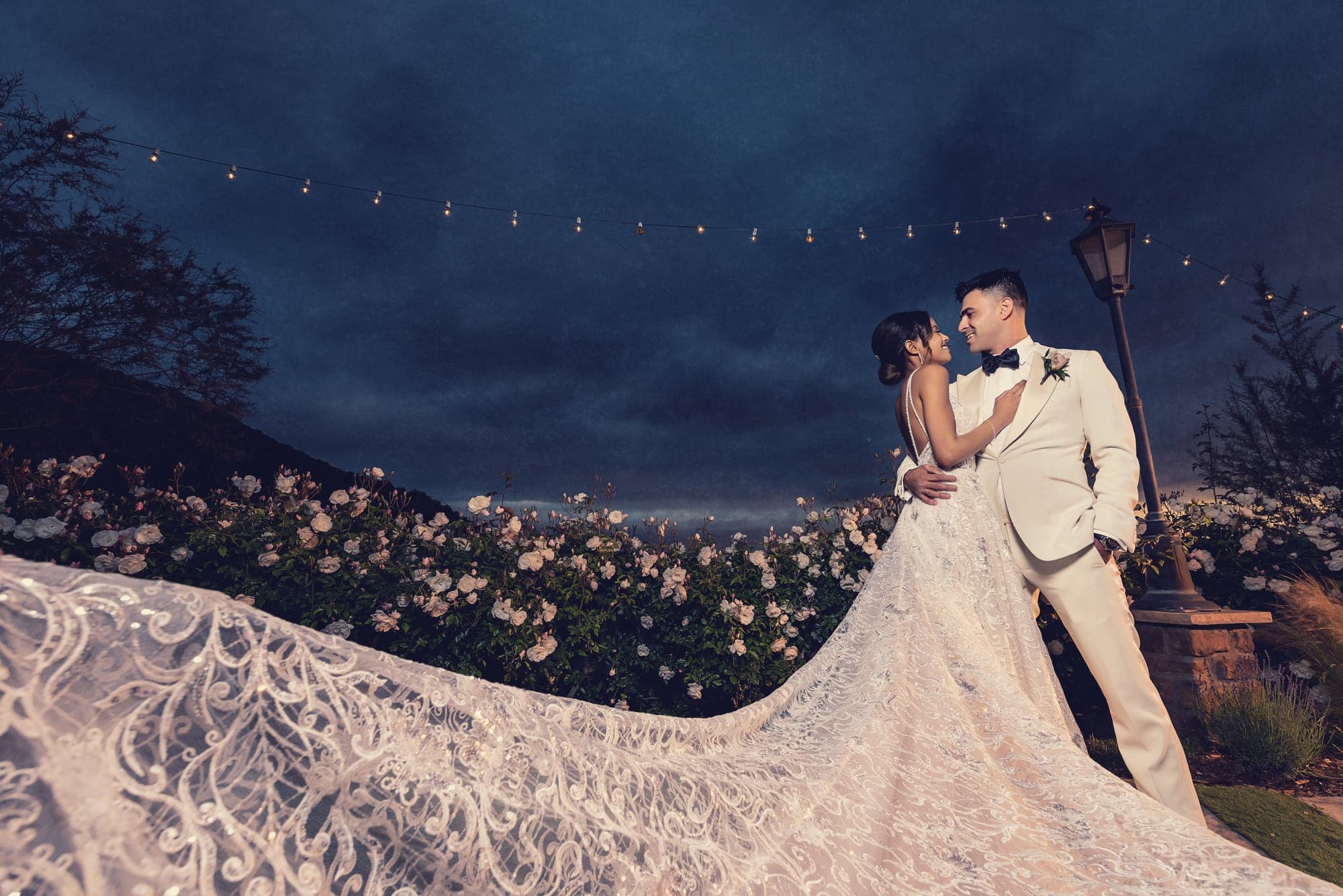 Dominique and Marc beneath a dramatic night sky at Serendipity Gardens