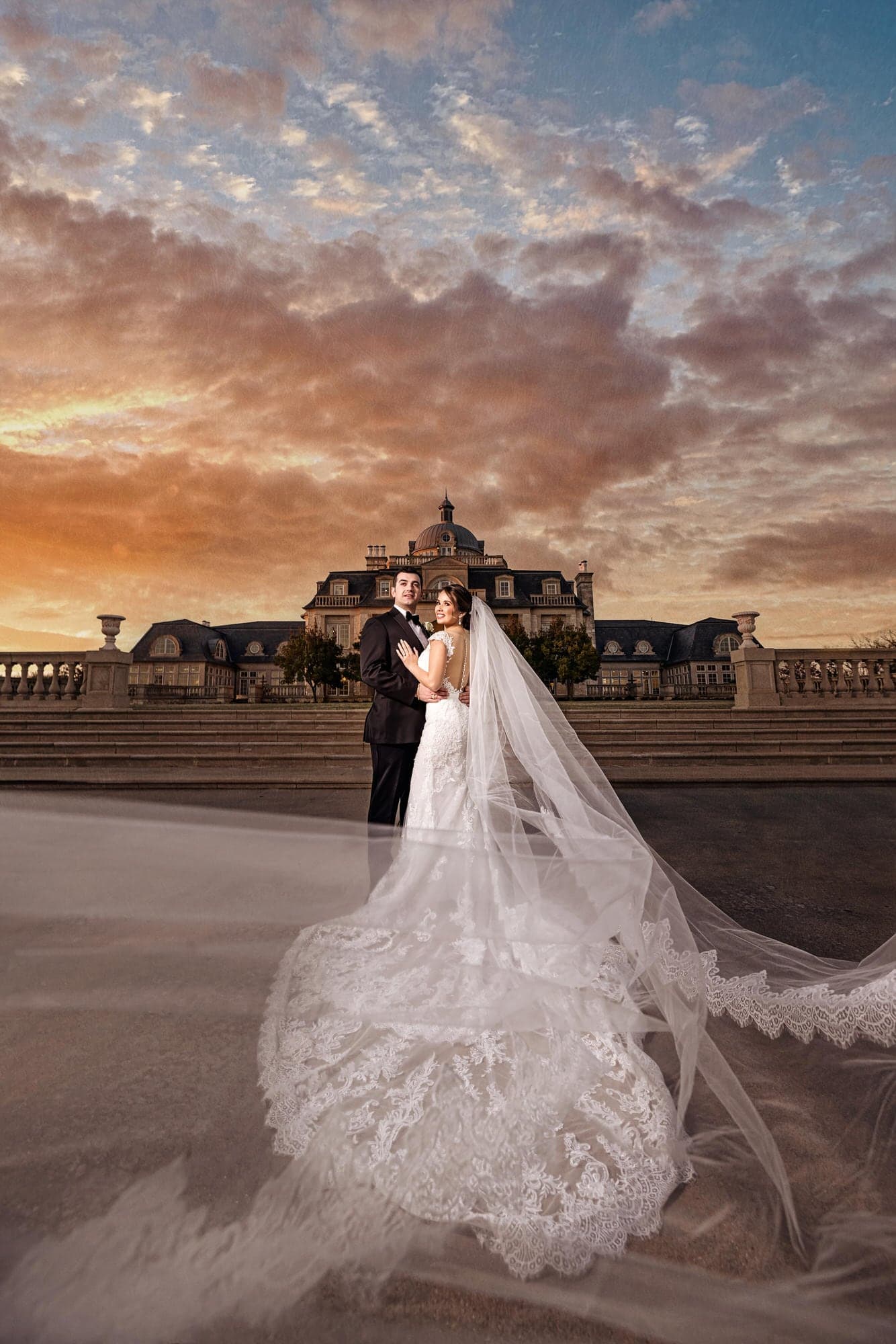 A grand white estate with tall columns and a reflecting pond glows at dusk under a soft Texas sky.