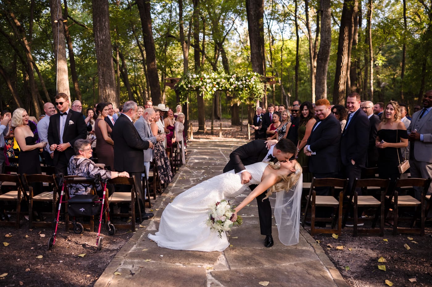Newlyweds sharing a joyful ceremony dip at The Springs in Waxahachie