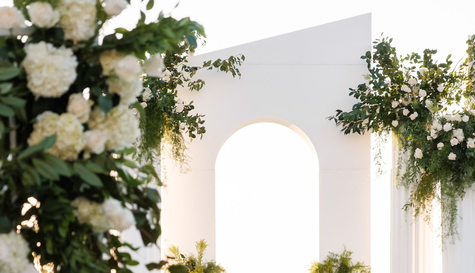 A coastal Southern California wedding venue at golden hour with the Pacific Ocean stretching behind the terrace