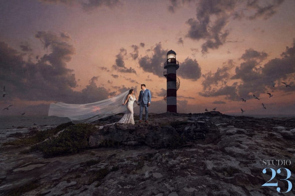 A Bride and Groom Standing by the Lighthouse during their Destination Wedding at The Hyatt Ziva Cancun